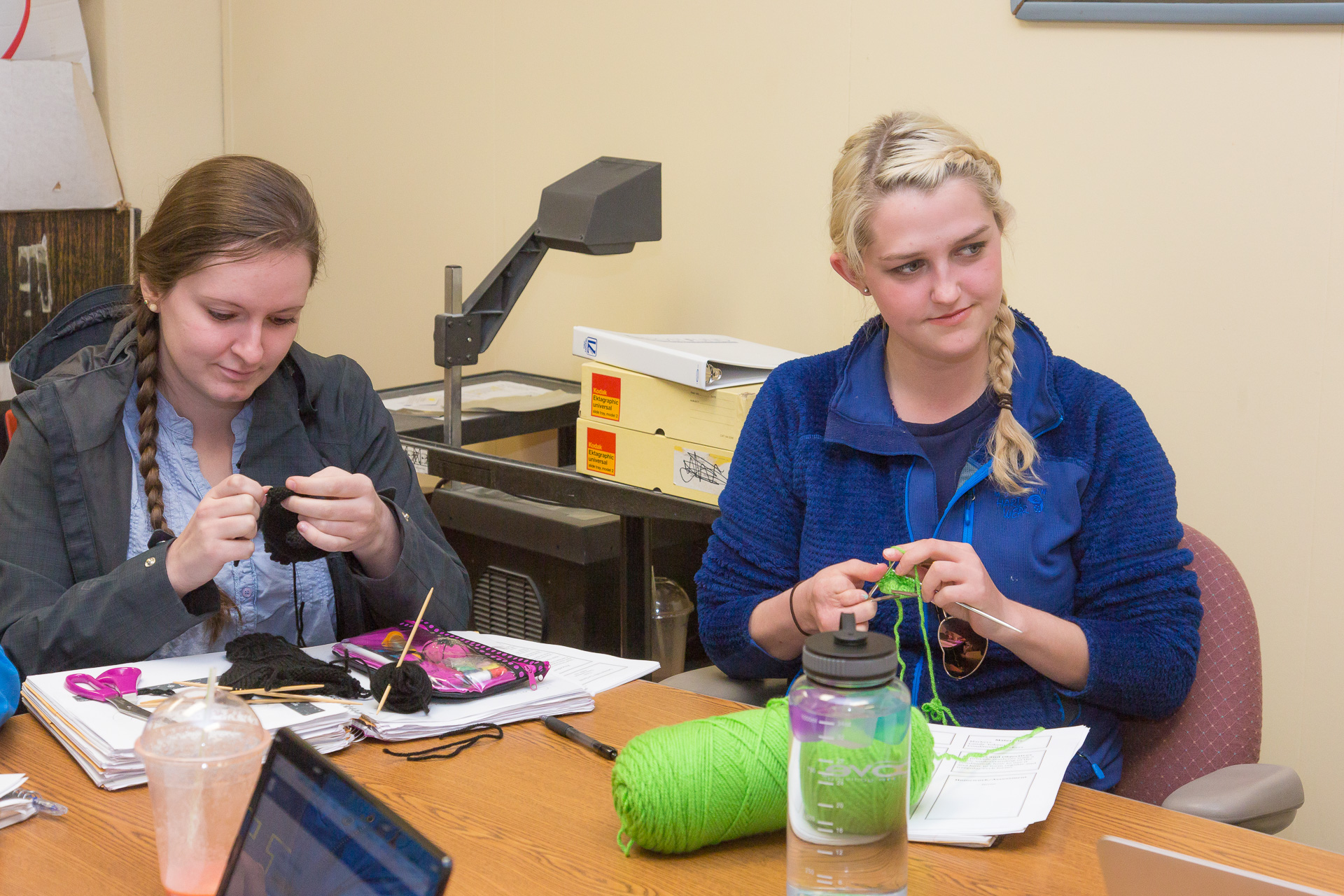 Claire Ashmead, left, and Michelle Strehl knit gloves for a customer with a unique hand shape. Strehl, whose own right hand was damaged when she was a child, began creating such gloves in 2013.