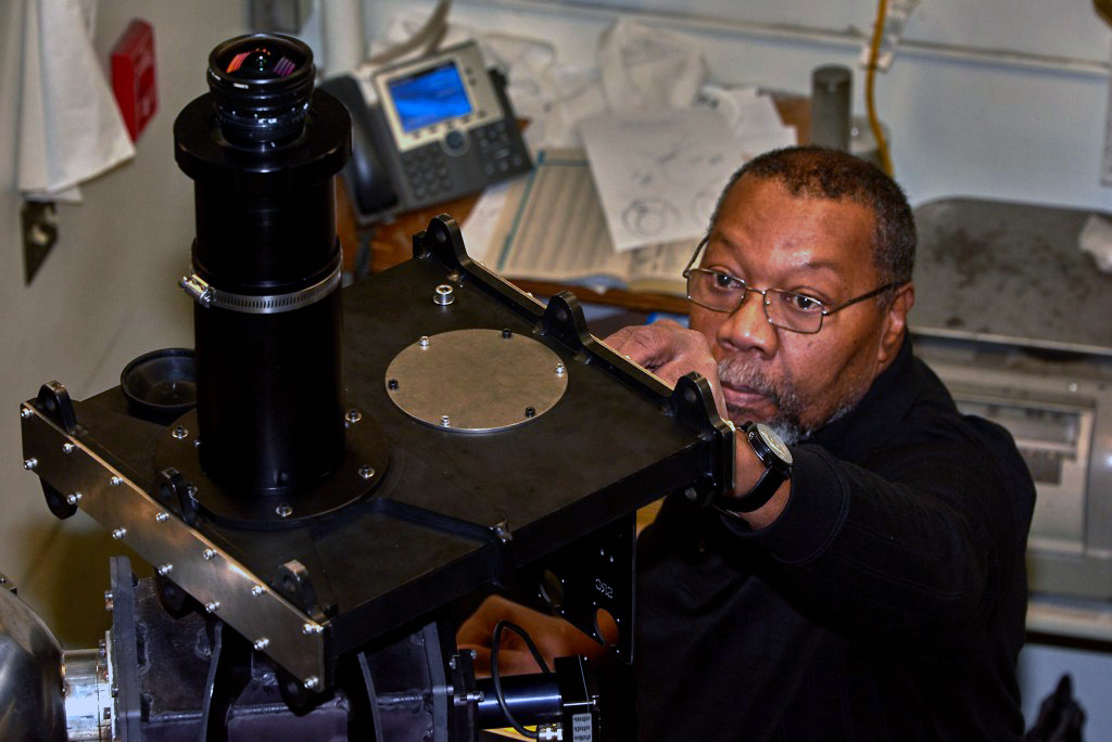 Greg Shipman, Instrument Development Services shop manager at the Geophysical Institute, adjusts a part on the scanning Doppler imager.