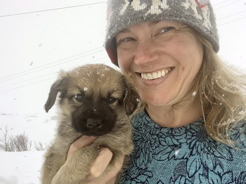 Photo courtesy Laurie Meythaler-Mullins Veterinarian Laurie Meythaler-Mullins holds a puppy in the village of Nightmute, Alaska.