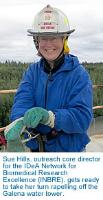 [Sue Hills gets ready to take her turn rapelling off the Galena water tower.]