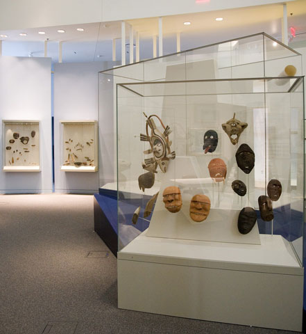 A museum display containing many Alaskan Native masks.