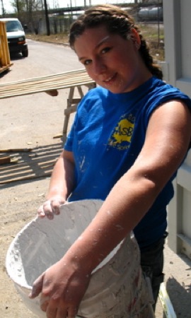 Tabitha Johnson prepares to clean out a paint bucket. Photo by Brian Lyke
