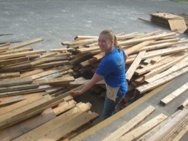 Cynthia Lashinski sorts recycled lumber at the Habitat warehouse. Photo by Clarissa Ribbens