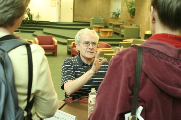 Terrence Cole discusses his book with participants at a book-signing event at the Wood Center.