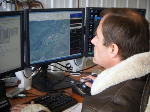 Photo by A. Hartley. Jeff Rothman, one of the three trained pilots of the university's unmanned aircraft, goes through a rigorous preflight checklist at the ground control station on April 12, 2010 at Poker Flat Research Range. 