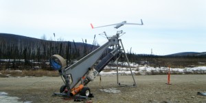 Photo by A. Hartley.  The 40-pound Insitu ScanEagle is catapulted from the launcher to begin a test flight at Poker Flat Research Range in preparation for the upcoming Alaska Shield Exercise. 