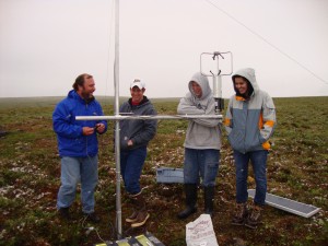 Photo by John Mayfield, Jr..  UAF associate professor Javier Fochesatto and students Joseph Woznicki, Kyle Imhoff and Jilmarie Stephens laugh as they work with a sonic anemometer installed at Toolik Field Station north of Fairbanks. 