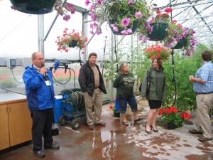 Photo Nancy Tarnai. SNRAS research professional Jeff Werner, left, explains about hydroponic growing at Pike's Tomato Greenhouse.