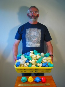 Photo courtesy of Dean Orbison.. Dean Orbison of Sitka with the 130 floating toys he and his family have found on Southeast Alaska beaches. The toys include green frogs, yellow ducks that have faded to a cream color, blue turtles, and red beavers that have faded to white.  
