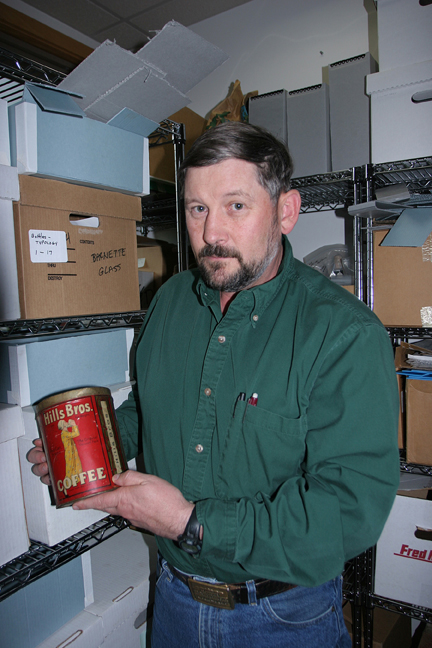 BLM photo by Craig McCaa..  Bureau of Land Management archaeologist Steve Lanford with a Hills Bros. coffee can.