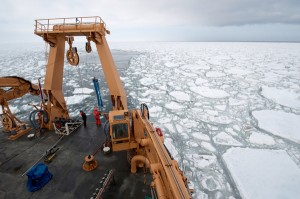 Photo by Chris Linder, Woods Hole Oceanographic Institution.  Alexei Pinchuk gets ready to deploy a collecting net on a ship in the Bering Sea.