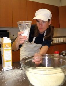 Photo by Jeff Fay . Research technician Kate Idzorek makes a batch of instant soups in the test kitchen at Extension’s state office in Fairbanks. 