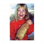 Photo courtesy of Ebbesson Farms.. As a little girl Britt Ebbesson (now a teenager) was happy with her four-pound potato.