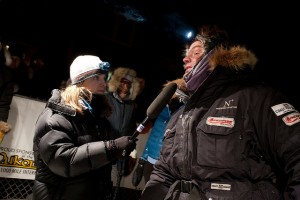 Photo courtesy of Rick Massie and the Yukon Quest. Emily Schwing interviews Ken Anderson at the Dawson checkpoint