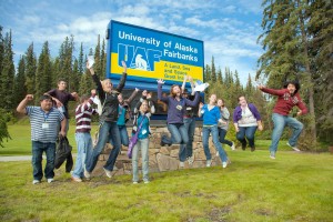 UAF photo by Maureen McCombs. Freshmen jump in front of the UAF time and temperature sign during the scavenger hunt as part of student orientation.