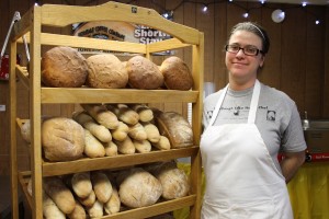 Photo by Nancy Tarnai. Jessica Aldabe prepares to sell freshly baked breads.