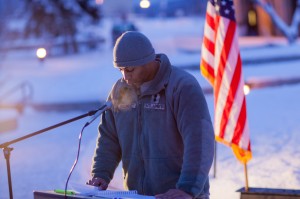 UAF ROTC cadet Ray Diamond takes an early 15-minute shift reading names of American service men and women killed during the wars in Iraq and Afghanistan during a Veterans' Day memorial ceremony in Constitution Park.