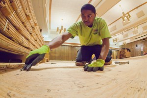 Steven James with MacChayne's Carpet Plus prepares the subfloor in the Wood Center Ballroom before installation of a new floor.