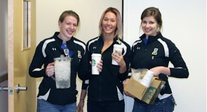 Britt Glaeser, Reilly Stevens and Robyn Timmer handing out free coffee around campus to thank all volleyball supporters.