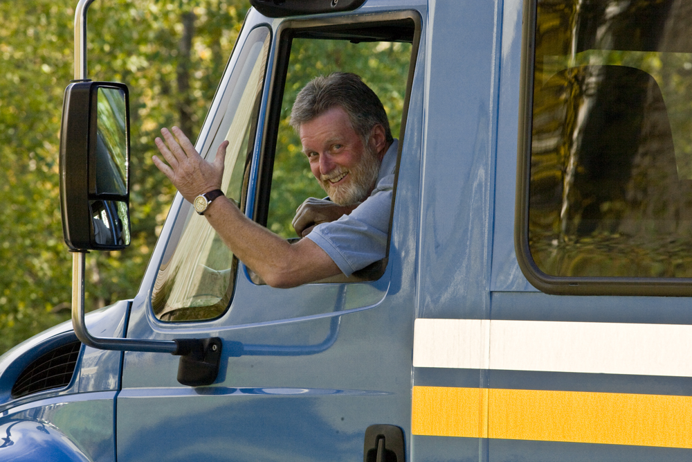 A shuttle bus driver waves as he makes his way around the Fairbanks campus. UAF photo by Todd Paris.