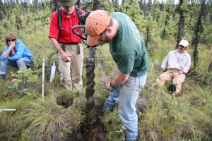 Photo by Glenn JudayArtist Phil Marshall (left) helps Jamie Hollingsworth, site manager for BNZ LTER, extract a permafrost core while learning about fire history in the Bonanza Creek LTER Rosie Creek Fire Study Area in August 2011.. 