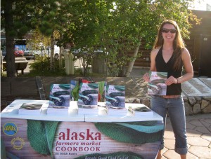 Photo courtesy of Heidi Rader. Heidi Rader with her cookbook at the Downtown Market.