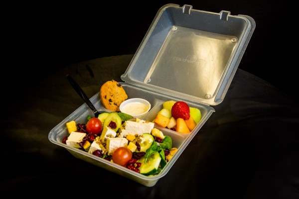 To-go box with salad, fruit and a cookie