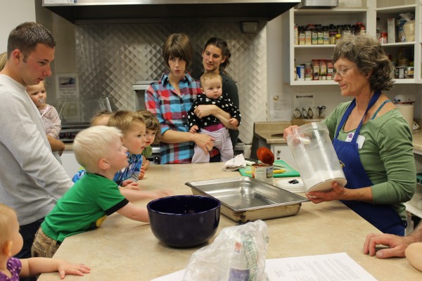 Marsha Munsell, right, teaches families how to prepare meals with vegetables.