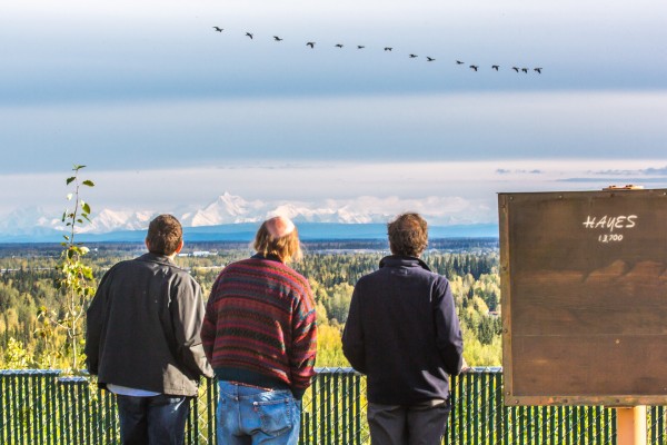 Visitors to campus enjoy the view of the Alaska Range and a passing flock of Canada geese on a September afternoon.