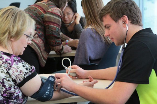 Participants of AIMES practice taking blood pressure. Photo courtesy of UAF's College of Natural Science & Mathematics.
