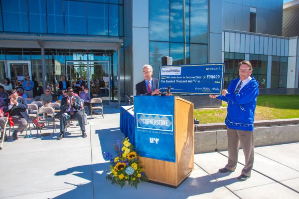 UAF photo by Todd Paris. Scott Jepsen, vice president external affairs for ConocoPhillips Alaska, presents a $500,000 donation to former UAF Chancellor Brian Rogers in July 2015.