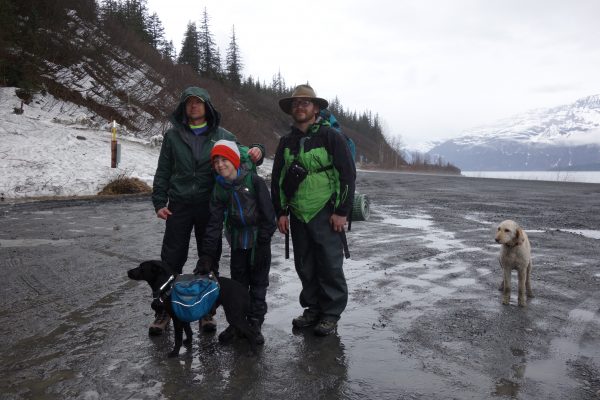 Photo by Kristen Rozell. From left, Ned Rozell and his friends Ian and Chris Carlson prepare to start hiking the path of the trans-Alaska pipeline in Valdez. Their dogs Cora, left, and Freya accompany them.