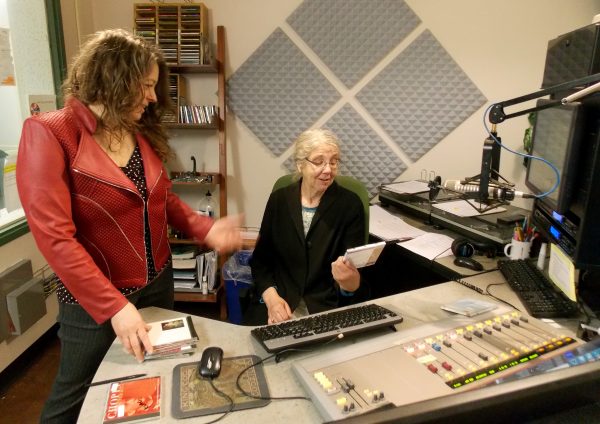 Photo by Nancy Tarnai.  Lori Neufeld, left, brainstorms with on-air volunteer Nora Foster in the KUAC FM studio.