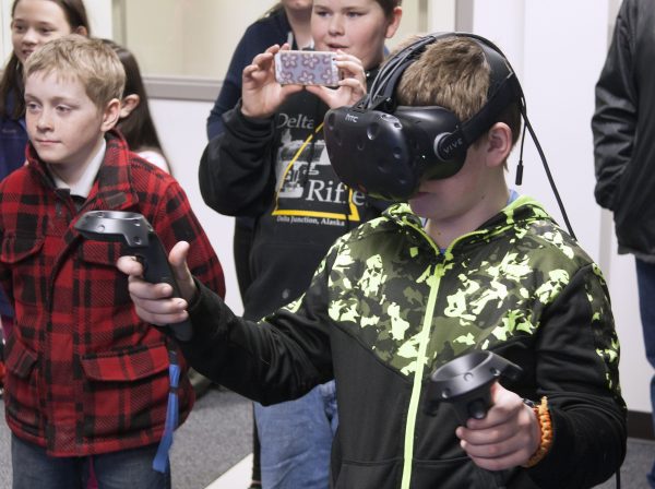 Tom Moran photo.  Grade school students from Delta Junction painted in virtual reality in the Decision Theater North development space during their Kids2College tour of UAF in April.