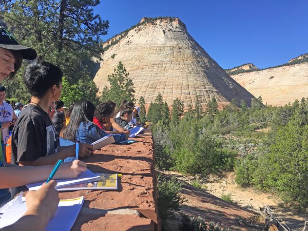Photo by Sylvia Hutchinson. GeoFORCE students take notes at Checkerboard Mesa near Zion National Park in Utah during the summer 2017 field trip.