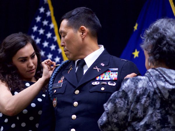 U.S. Army photo by Sgt. David Bedard. Alaska Army National Guard Col. Wayne Don, 38th Troop Command commander, looks on as his daughter, Phylicia, left, and mother, Annie, pin on full colonel rank insignia during a 2017 promotion ceremony at the Dena'ina Center in Anchorage.