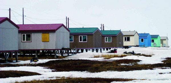 Photo courtesy of Alaska Department of Commerce.  Homes in the North Slope village of Nuiqsut rest on pilings set in the permafrost soil.