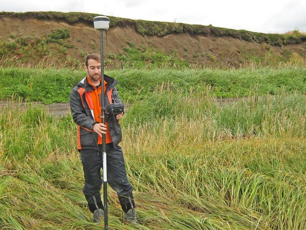 Photo by Chris Maio.  Rich Buzard takes a precise topographic measurement using a real-time kinematic GPS system in 2016.
