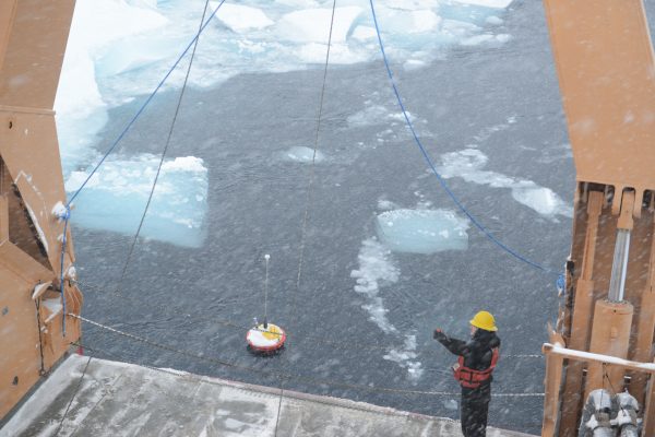 Photo by Ignatius Rigor of the Polar Science Center, Applied Physics Laboratory University of Washington.. A seasonal ice beacon floats in the Arctic Ocean after a research team deploys it from the ice breaker, the USCGC Healy.