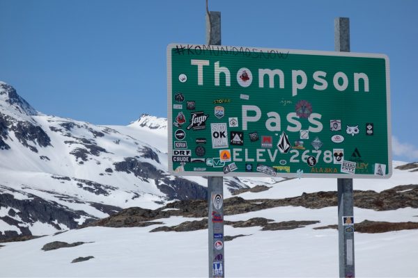 Photo by Ned Rozell.  Stickers adorn the sign at Thompson Pass, one of Alaska's snowiest spots, on the Richardson Highway about 25 miles east of Valdez.