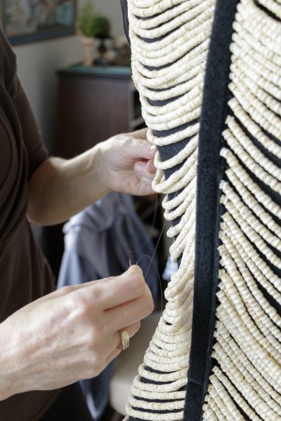 Photo by Stephanie Lambdin.  Sitka artist Cynthia Gibson works on her salmon bone dress, which contains approximately 20,000 vertebrae.