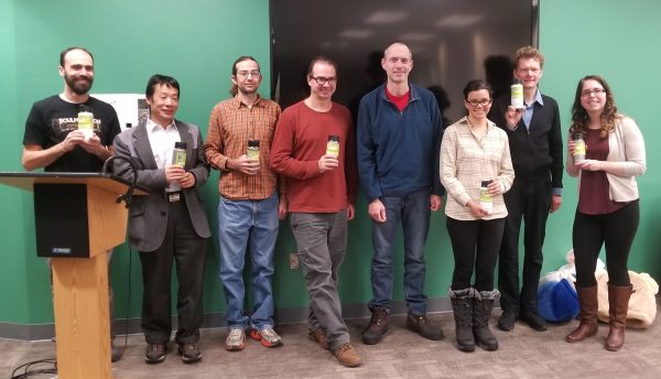 Photo by Amanda Byrd.  Members of the winning team in the 2017 PredictFest, who created an app for predicting winter snow-related costs, hold their water bottle prizes.
