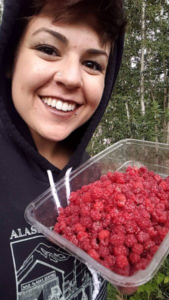 Photo courtesy of Caitlin Tozier.  Caitlin Tozier holds freshly picked raspberries in fall 2017.