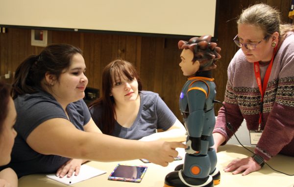 Yuri Bult-Ito photo.  Participants in the 2018 Educators Rising Alaska State Conference interact with Milo, a robot created for autistic children in special education.