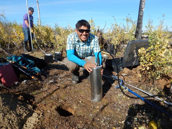 Photo by Carl Tape. University of Alaska Fairbanks doctoral student Kyle Smith installs a T120 posthole seismometer at a site in the Minto Flats of central Alaska in September, 2015.