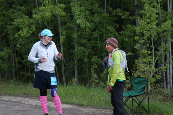 Photo by Chris Carlson. Laura Southwell of Anchorage and Carmen Klooster of Fairbanks take a break after completing a 6-mile lap in the Alaska Endurance Trail Run, held on the UAF campus.