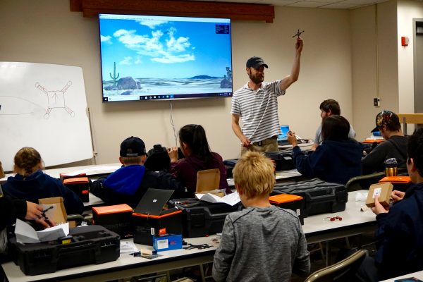 Photo by Patty Eagan. Matthew Westhoff, a pilot with UAF's ACUASI, teaches students about drones at a camp in June.