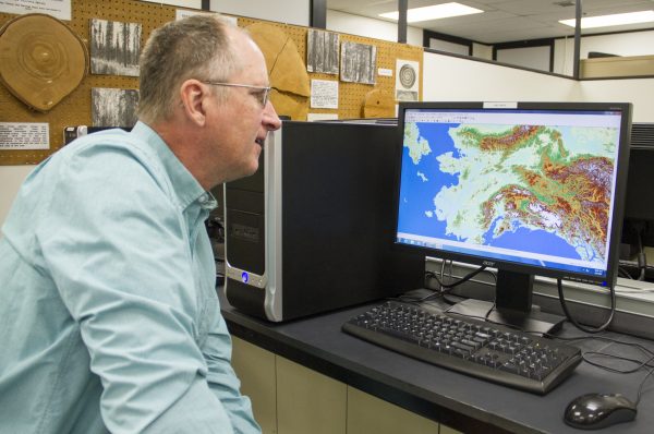 Jeff Fay photo. Dave Verbyla looks at remote sensing data on elevation that is displayed using ArcGIS mapping software.