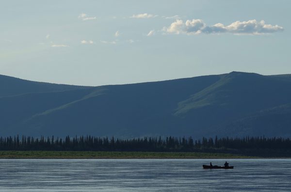 Photo by Skip Ambrose. Cora the dog and Ned Rozell float down the Yukon River just upstream from Circle.