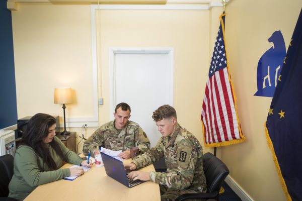 UAF photo by JR Ancheta. Student assistant Cierra Blalock helps ROTC cadets Robert Olinger, center, and Dalton Stone, right, with paperwork at the UAF Department of Military and Veteran Services office. The new office suite is in Room 104 of the Eielson Building.